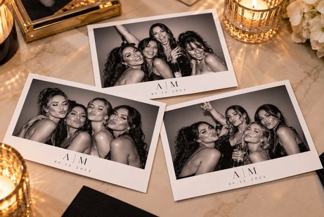 Large personalized photo booth prints on a wedding table