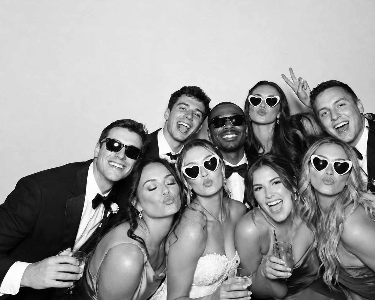 Black-and-white photo booth portrait of wedding guests