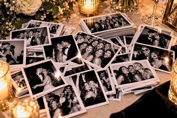 Glam Booth prints arranged on a wedding table