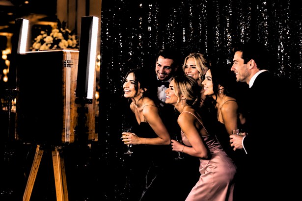 Guests posing at the Retro photo booth