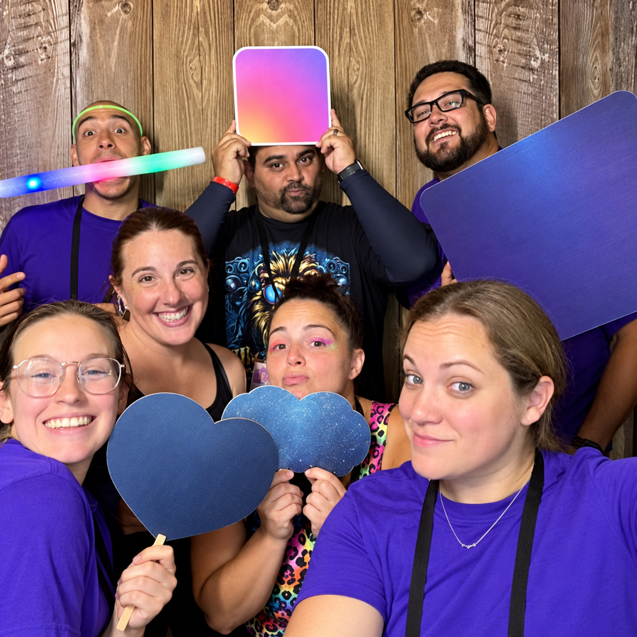 Guests posing with colorful props at a dance gala photo booth
