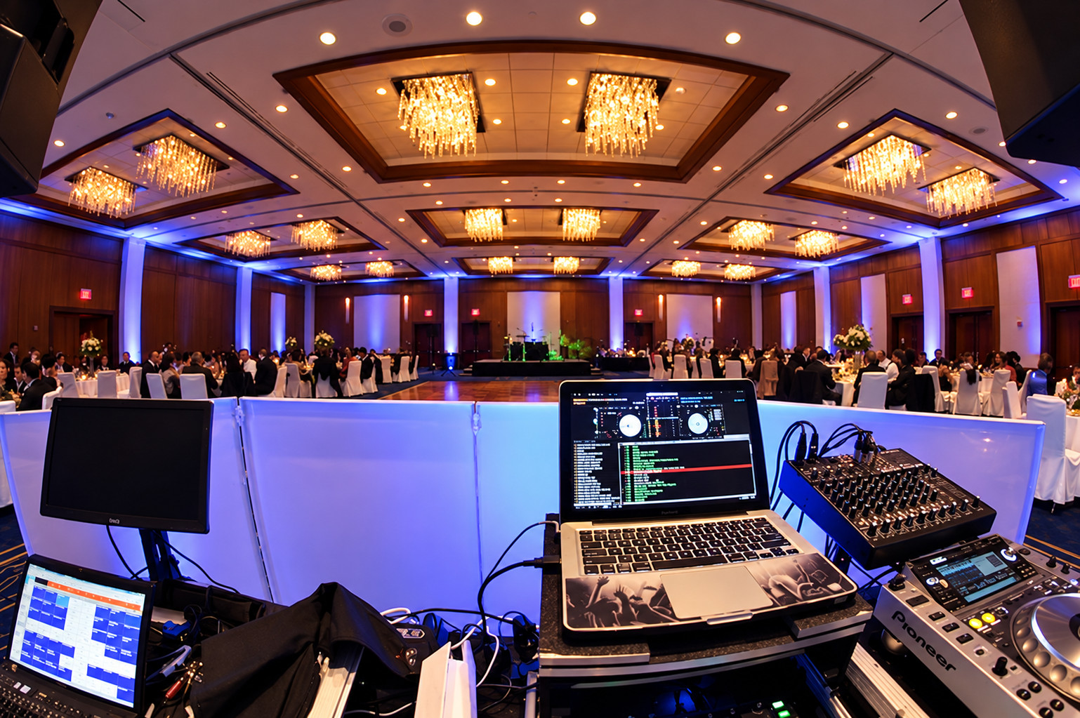 Event production console overlooking a ballroom reception