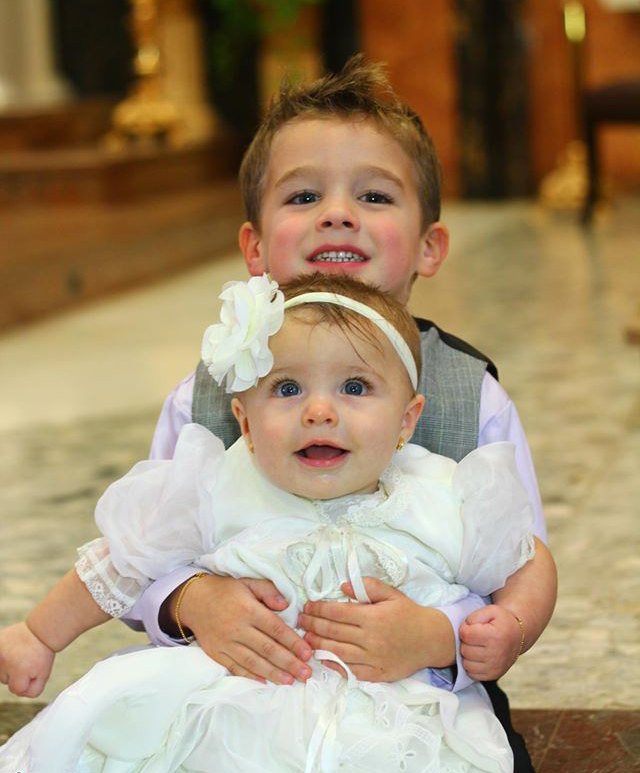 Two young children sharing a joyful family moment