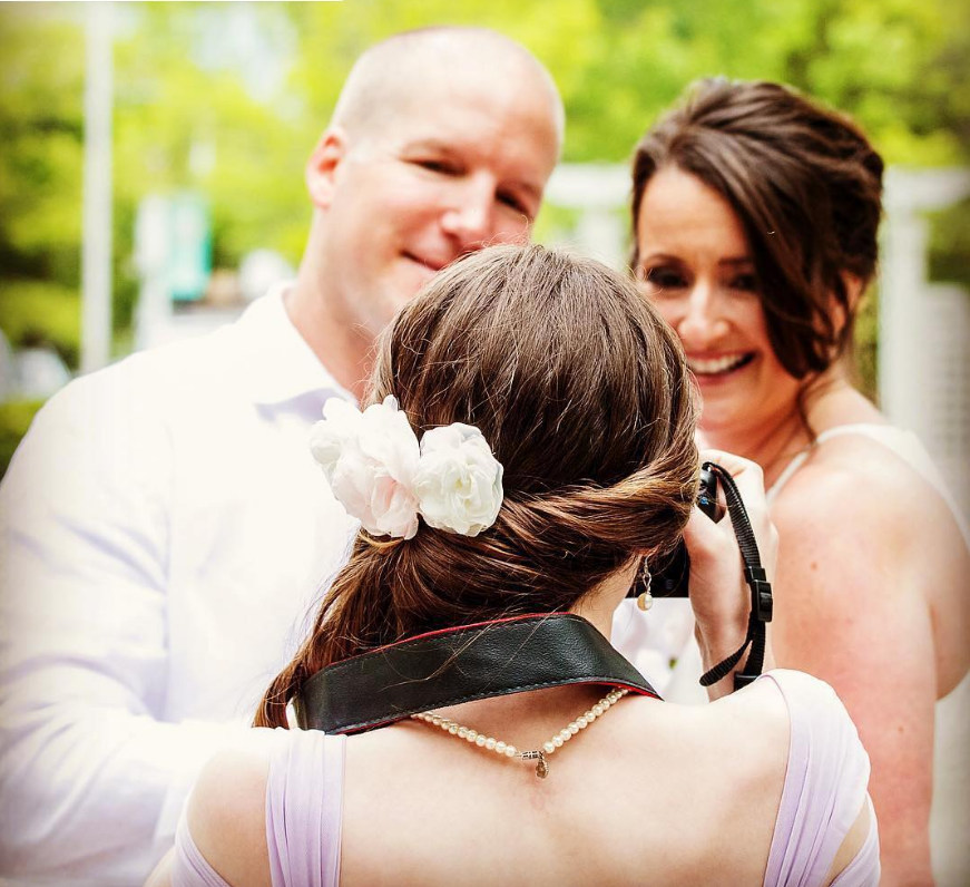 An event photographer documenting a wedding moment
