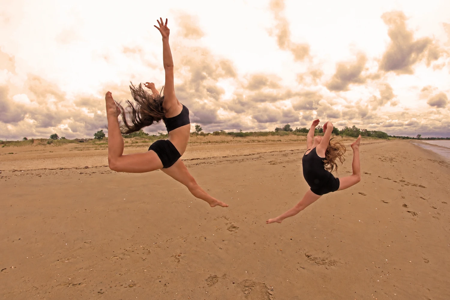 Dancers leaping on the beach
