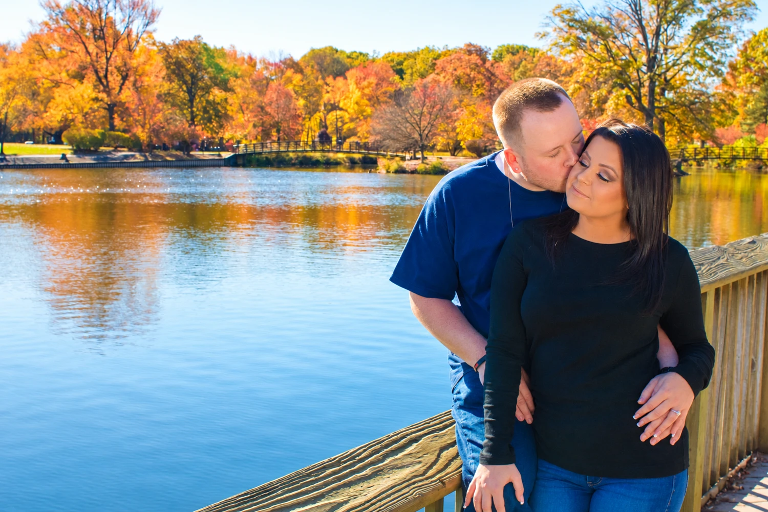 Couple together beside an autumn lake